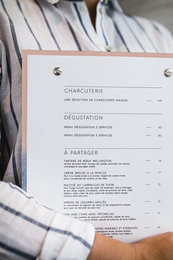 waiter holds french Hopkins menu